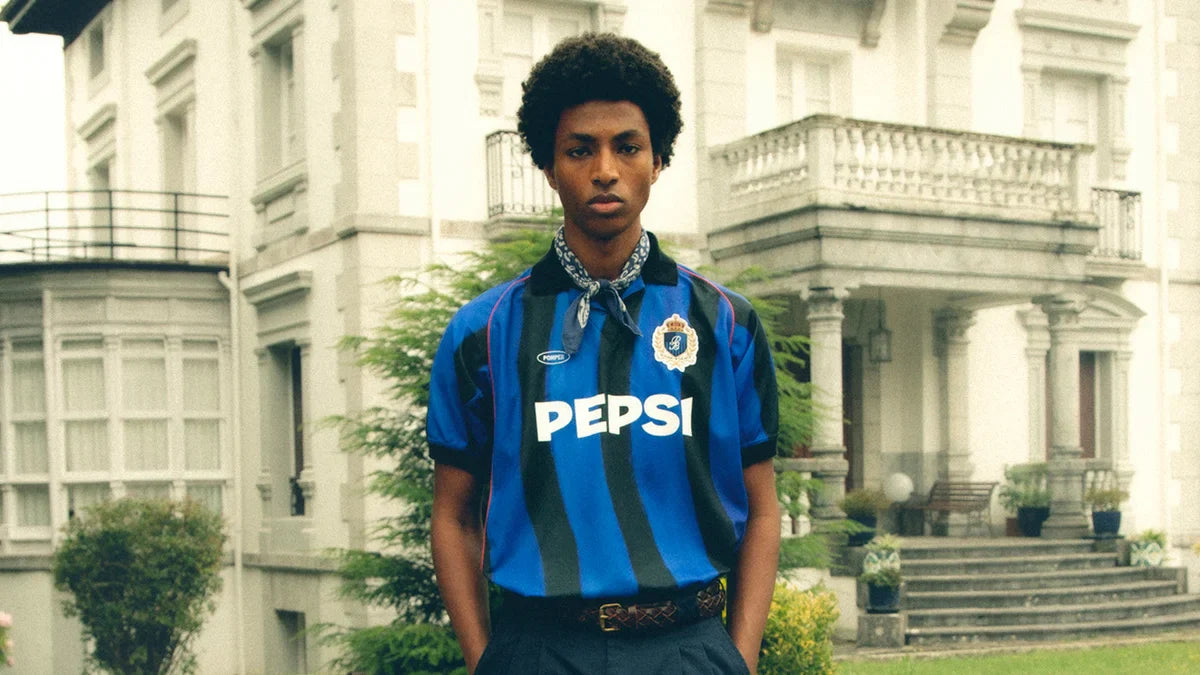 An image of a man wearing blokecore fashion (football kit X streetwear)