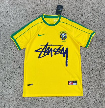 A short-sleeved soccer jersey in yellow with green accents, featuring the Nike logo and the name &